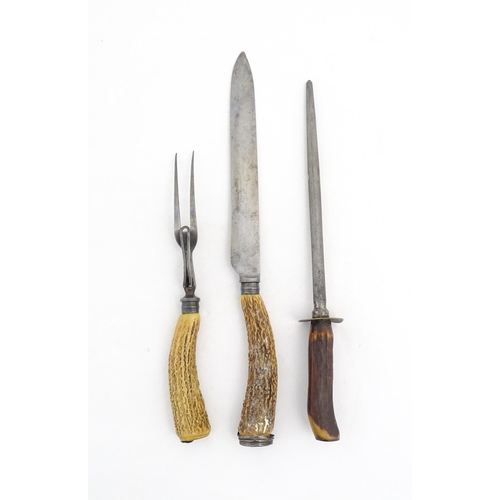 1083 - A Victorian carving knife and fork with antler handles and silver collar. Together with an antler ha... 