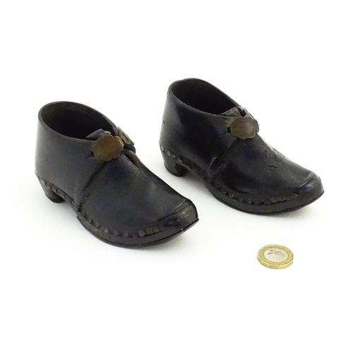 1138 - A pair of late 19th / early 20thC children's leather Lancashire clogs with stud detail and wooden an... 