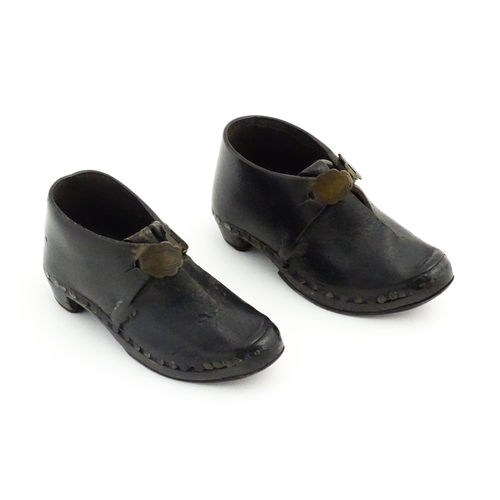 1138 - A pair of late 19th / early 20thC children's leather Lancashire clogs with stud detail and wooden an... 