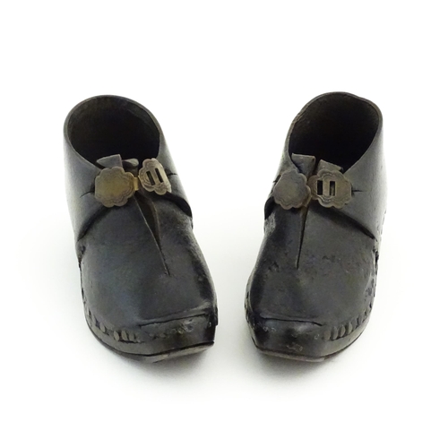 1138 - A pair of late 19th / early 20thC children's leather Lancashire clogs with stud detail and wooden an... 