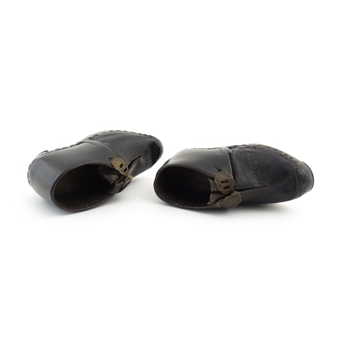 1138 - A pair of late 19th / early 20thC children's leather Lancashire clogs with stud detail and wooden an... 