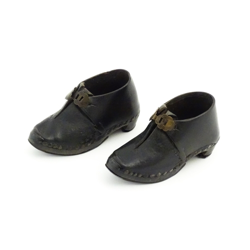 1138 - A pair of late 19th / early 20thC children's leather Lancashire clogs with stud detail and wooden an... 