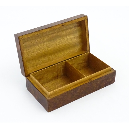 1139 - A 20thC table top cigarette box with burr veneers. Approx. 2 1/4