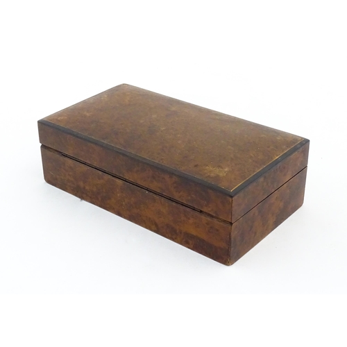 1139 - A 20thC table top cigarette box with burr veneers. Approx. 2 1/4