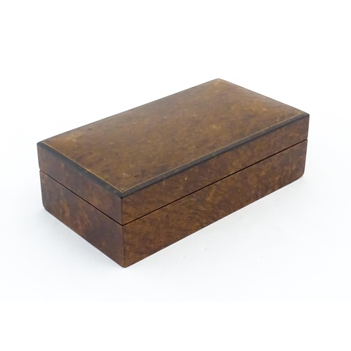 1139 - A 20thC table top cigarette box with burr veneers. Approx. 2 1/4