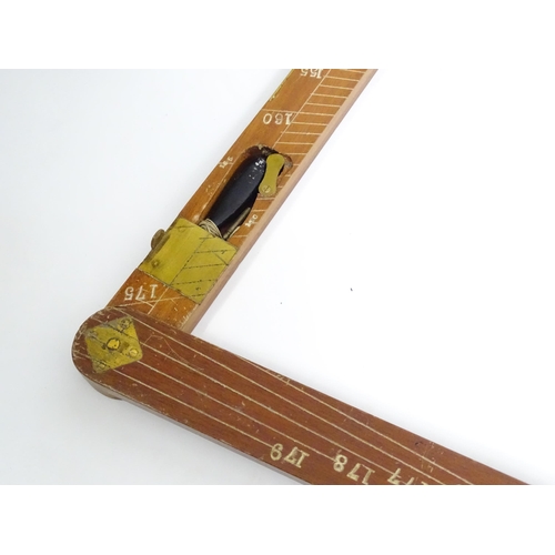 1150 - An M.D.S. Ltd. surveyor's folding triangle rule with inset spirit level and plumb bob. No. B.49645. ... 