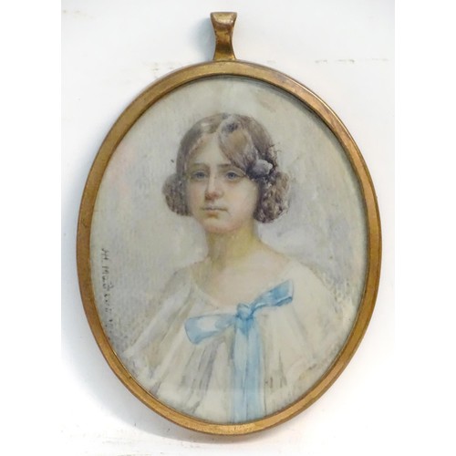 1155 - A 20thC watercolour portrait miniature depicting a seated young girl in a white dress with a blue bo... 