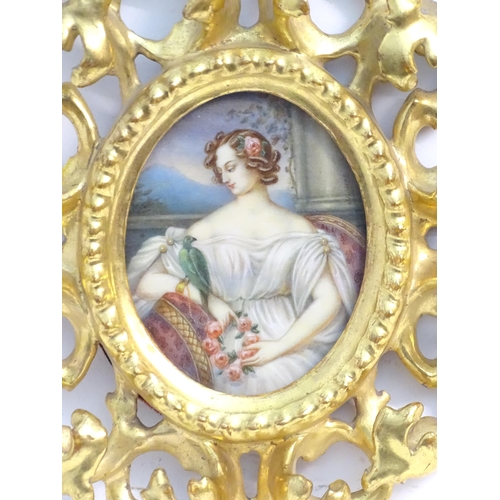 1156 - A 20thC oval watercolour portrait miniature depicting a seated maiden with a wreath of flowers and a... 