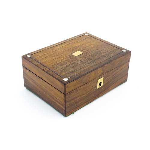 1164 - A 20thC rosewood jewellery box with inlaid brass and mother of pearl detail, the hinged lid opening ... 