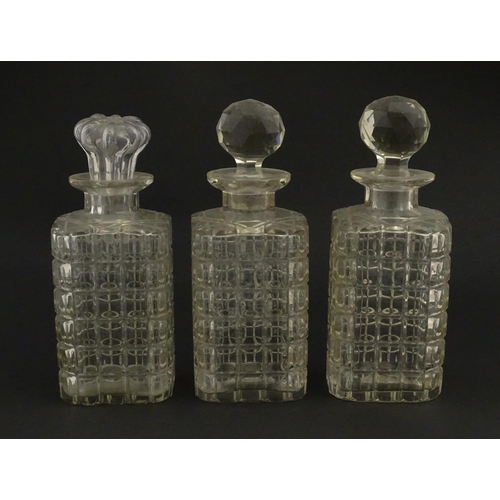 1224 - A 20thC oak tantalus with three glass decanters. Approx. 12