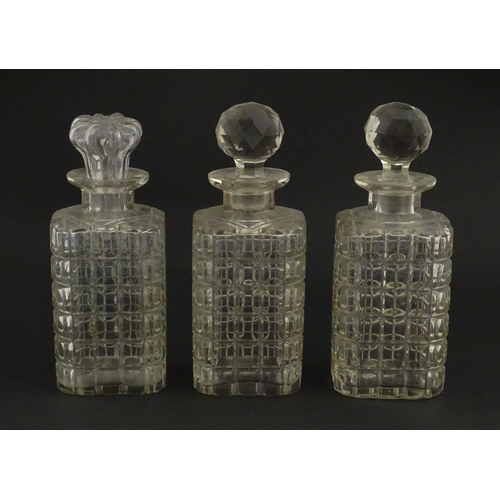 1224 - A 20thC oak tantalus with three glass decanters. Approx. 12