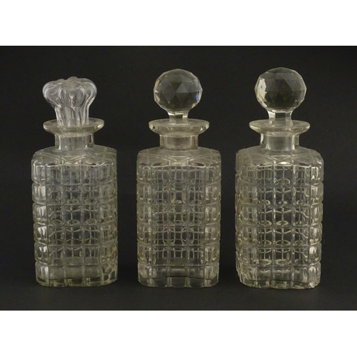 1224 - A 20thC oak tantalus with three glass decanters. Approx. 12