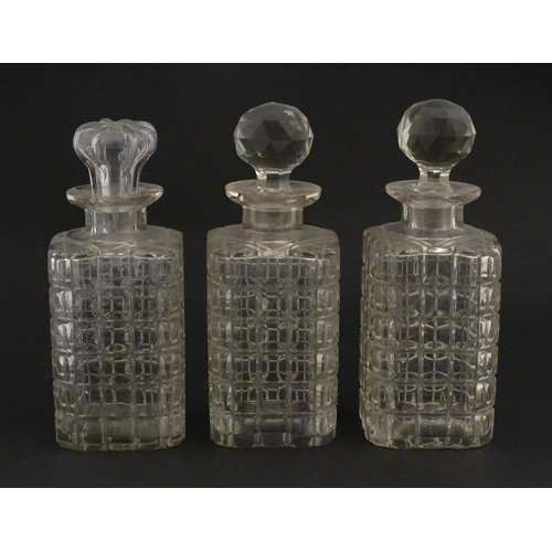 1224 - A 20thC oak tantalus with three glass decanters. Approx. 12