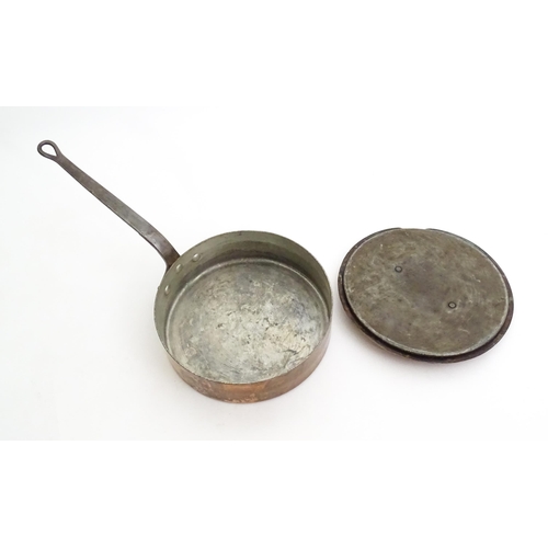 1235 - A large Continental copper saute pan with cast iron handle, the cover with a brass handle. Stamped S... 