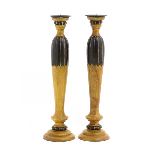 1240 - A pair of 20thC treen turned wooden candlesticks with painted and incised decoration. Approx. 14