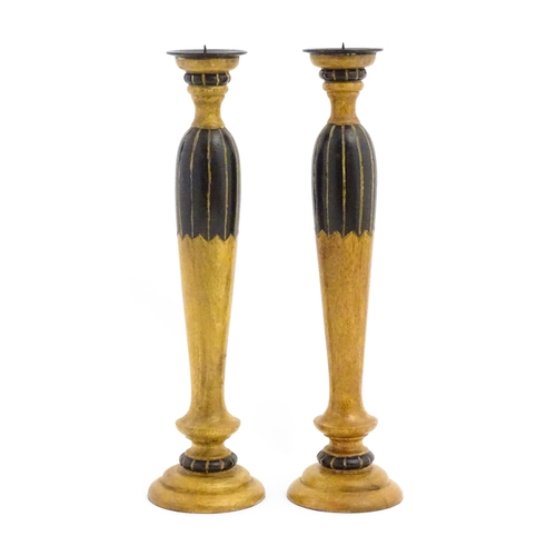 1240 - A pair of 20thC treen turned wooden candlesticks with painted and incised decoration. Approx. 14