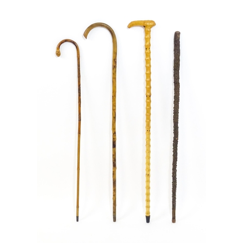 1250 - Sticks / Canes : Four assorted walking stick / canes to include an example with carved Oriental deco... 