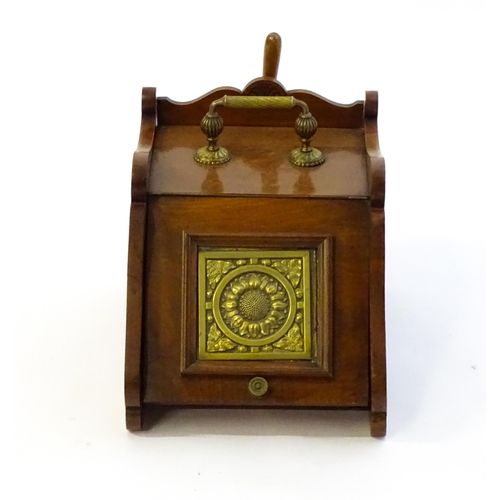 1262 - An early 20thC mahogany coal scuttle with a gadrooned handle above a fall front with an embossed bra... 