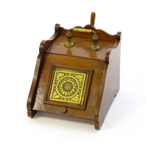 1262 - An early 20thC mahogany coal scuttle with a gadrooned handle above a fall front with an embossed bra... 