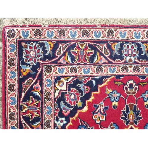 1273 - Carpet / Rug: A Central Persian kashan runner, the red ground with blue and cream ground motifs, flo... 