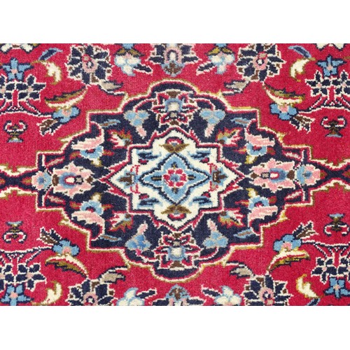 1273 - Carpet / Rug: A Central Persian kashan runner, the red ground with blue and cream ground motifs, flo... 