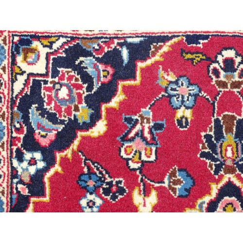 1273 - Carpet / Rug: A Central Persian kashan runner, the red ground with blue and cream ground motifs, flo... 