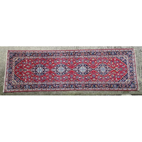 1273 - Carpet / Rug: A Central Persian kashan runner, the red ground with blue and cream ground motifs, flo... 