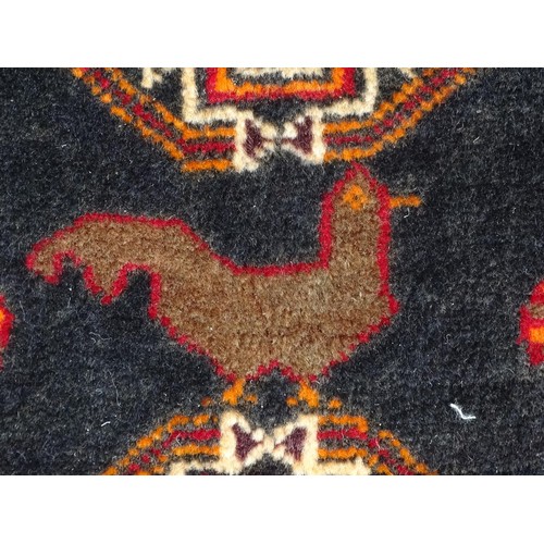 1274 - A North East Persian Turkoman rug with repeating medallions of geometric decoration and bird detail.... 