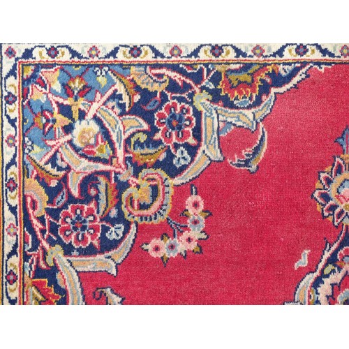 1275 - Carpet / Rug : A Central Persian Kashan Rug the red ground with central vignette having floral and f... 