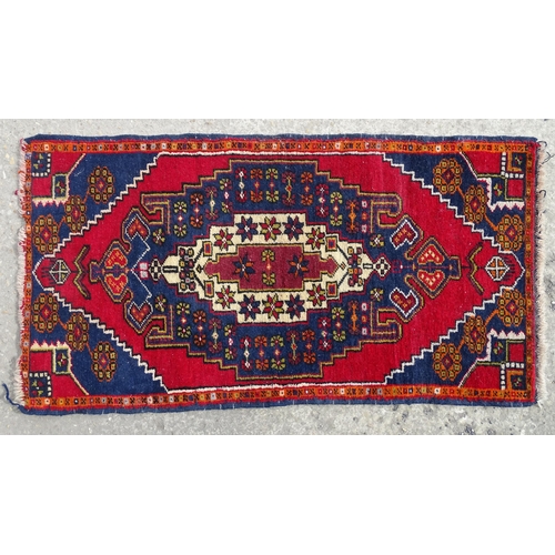 1278 - Carpet / Rug : A rug with red, blue and cream ground having central medallion with stylised floral d... 