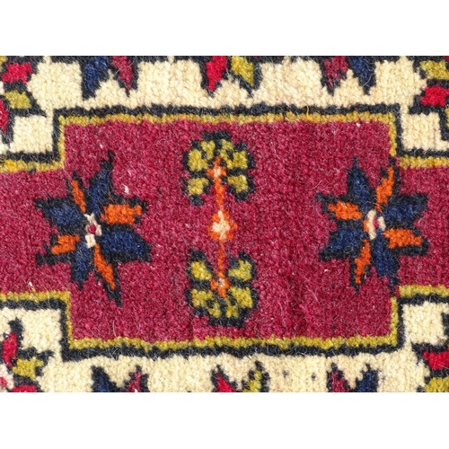 1278 - Carpet / Rug : A rug with red, blue and cream ground having central medallion with stylised floral d... 