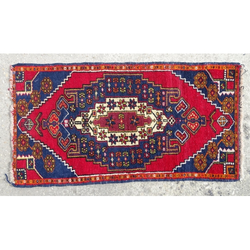 1278 - Carpet / Rug : A rug with red, blue and cream ground having central medallion with stylised floral d... 