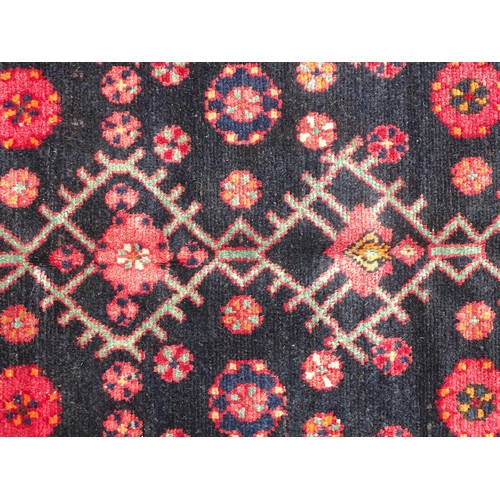 1280 - Carpet / Rug : A North west Persian Hamadan rug, the blue ground with repeating floral motifs within... 