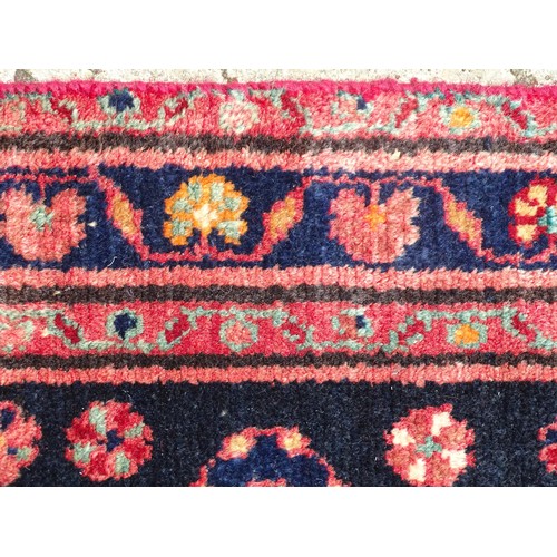 1280 - Carpet / Rug : A North west Persian Hamadan rug, the blue ground with repeating floral motifs within... 