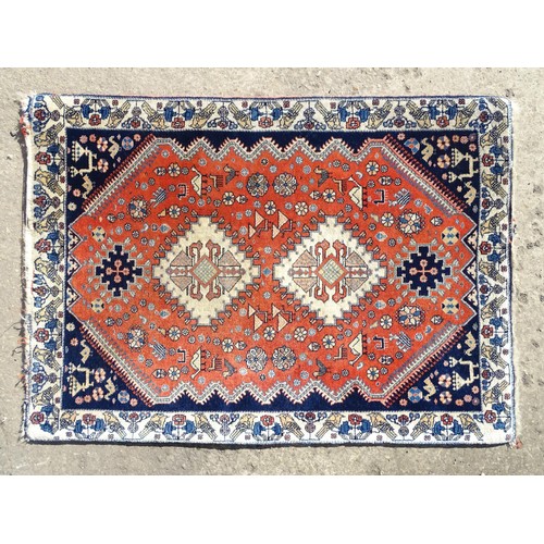 1282 - Carpet / Rug : A wool rug with central red ground with geometric medallions and stylised animal deta... 