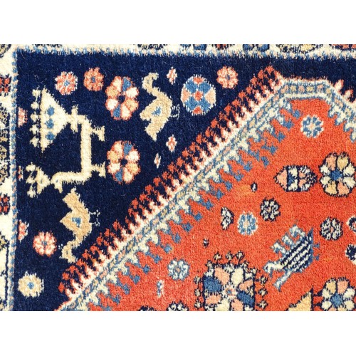 1282 - Carpet / Rug : A wool rug with central red ground with geometric medallions and stylised animal deta... 