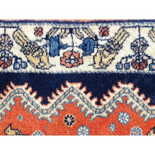 1282 - Carpet / Rug : A wool rug with central red ground with geometric medallions and stylised animal deta... 