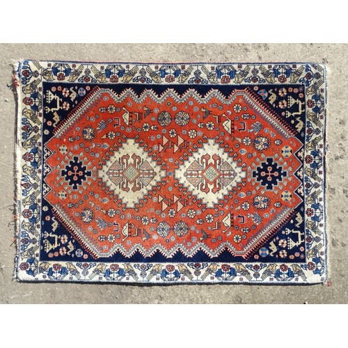 1282 - Carpet / Rug : A wool rug with central red ground with geometric medallions and stylised animal deta... 