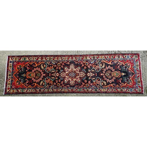 1283 - Carpet / Rug : A North west Persian Hamadam runner. The dark ground with floral and foliate motifs w... 