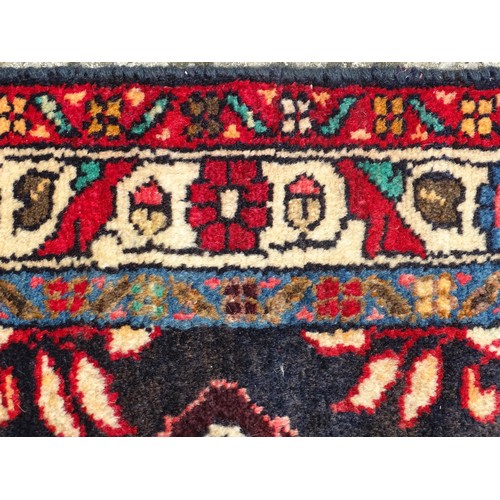 1283 - Carpet / Rug : A North west Persian Hamadam runner. The dark ground with floral and foliate motifs w... 