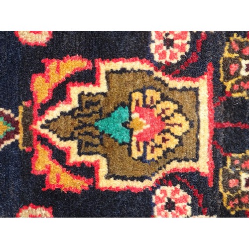 1283 - Carpet / Rug : A North west Persian Hamadam runner. The dark ground with floral and foliate motifs w... 