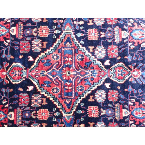 1284 - Carpet / Rug : A  North west Persian Nahawand rug, the blue and red grounds with floral and foliate ... 