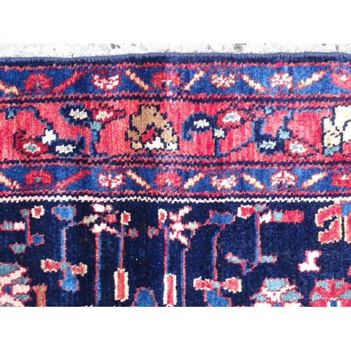 1284 - Carpet / Rug : A  North west Persian Nahawand rug, the blue and red grounds with floral and foliate ... 