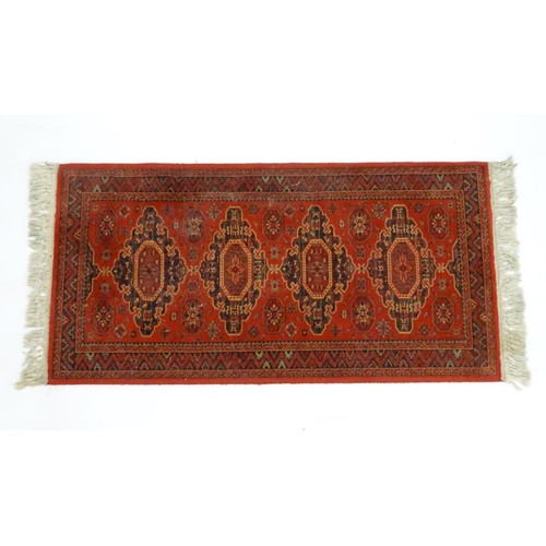 1288 - Carpet / Rug :  A red ground rug with four central medallions with geometric detail and border. Appr... 