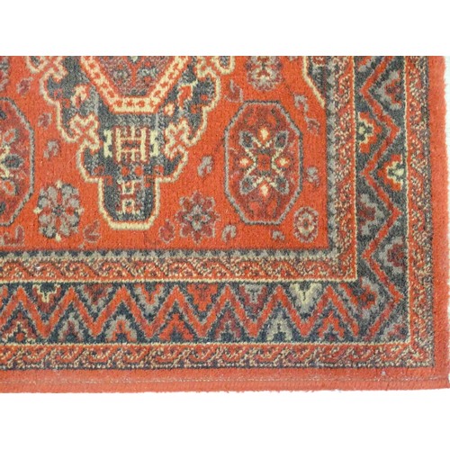 1288 - Carpet / Rug :  A red ground rug with four central medallions with geometric detail and border. Appr... 