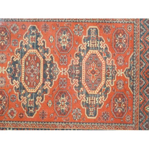 1288 - Carpet / Rug :  A red ground rug with four central medallions with geometric detail and border. Appr... 