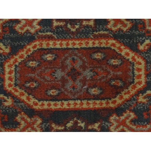 1288 - Carpet / Rug :  A red ground rug with four central medallions with geometric detail and border. Appr... 