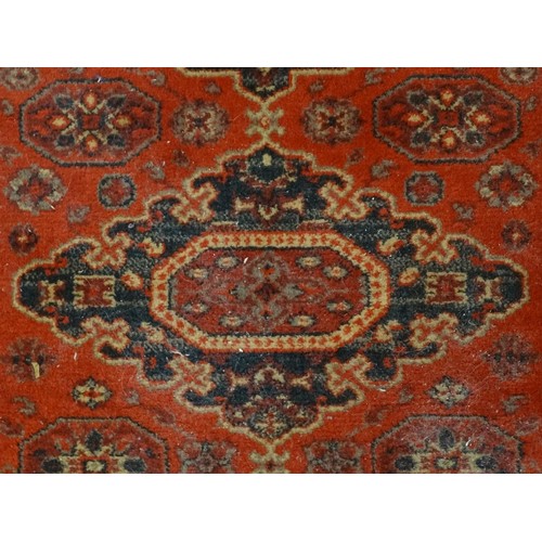 1288 - Carpet / Rug :  A red ground rug with four central medallions with geometric detail and border. Appr... 