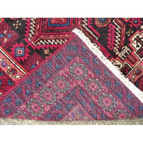 1289 - Carpet / Rug : A North east Persian meshed Belouch rug with geometric motifs and banded borders with... 