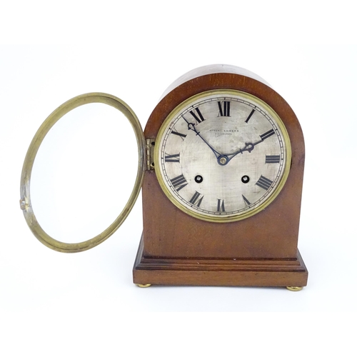 1299 - A mahogany cased mantle clock, the silvered dial with roman numerals and signed Robert Sawers Edinbu... 